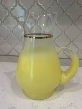 Mid century West Virginia Glass Blendo yellow frosted pitcher with a gold rim